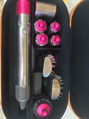 Dyson multi-styler in silver with bright pink accents